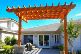 Bright suburban home with renovated exterior, cedar pergola over patio, lush landscaping, and clear blue sky, showcasing modern upgrades and curb a...